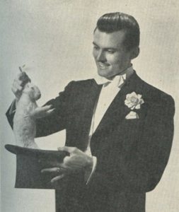 A magician pulls a rabbit out of a hat